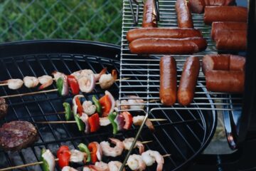 saucisse grillée et viande à côté d'une clôture grillagée grise